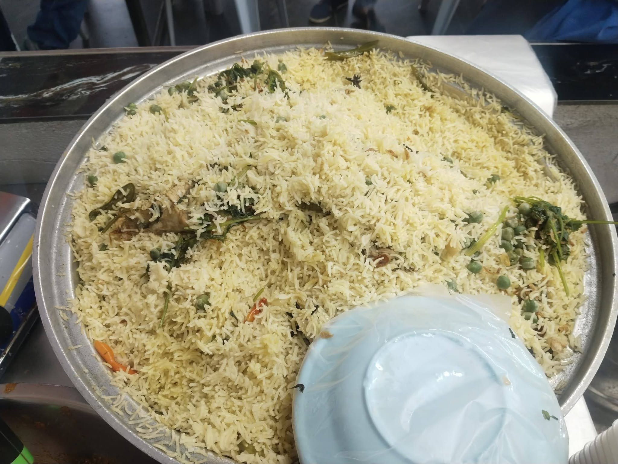 Briyani rice cooking in large rice cookers during catering